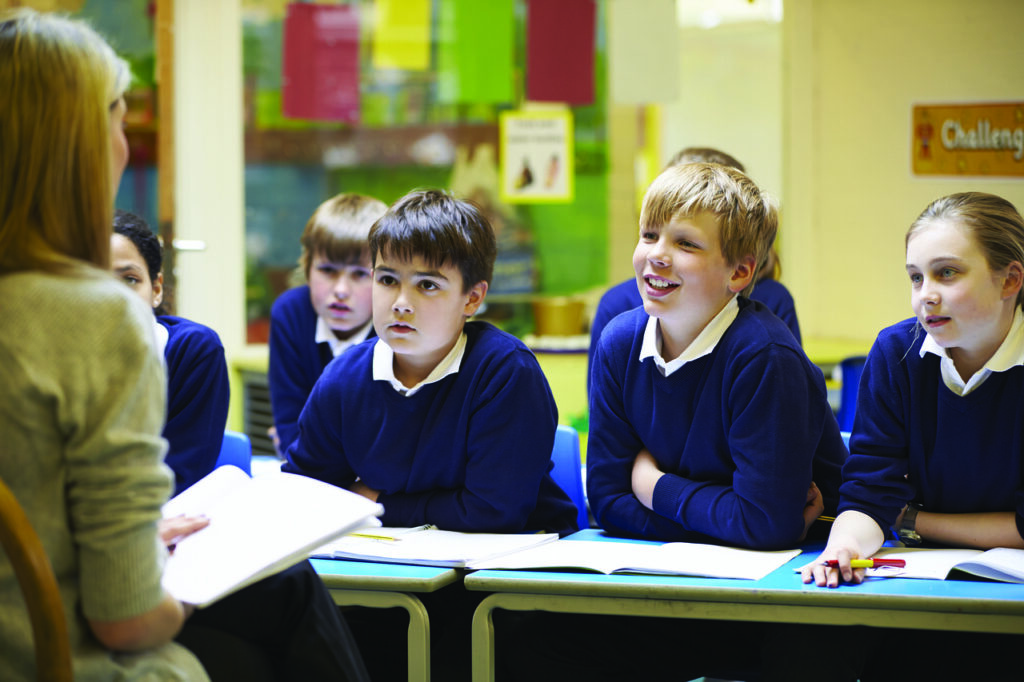 The teacher and students are in the classroom.