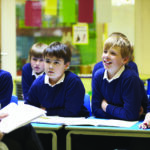The teacher and students are in the classroom.