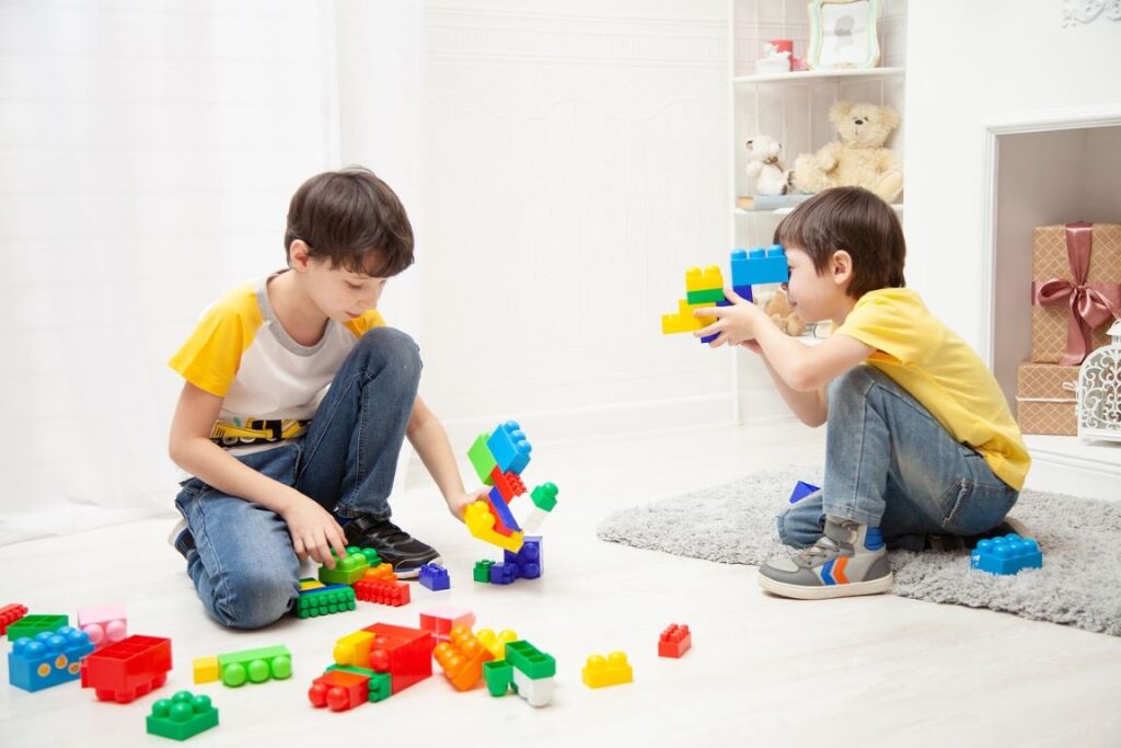 The boys playing with building blocks