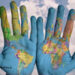 The world map coloured on open hands